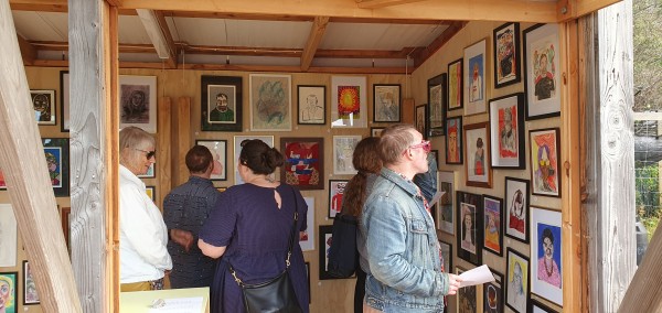 4 people looking at Shed Gallery Opening exhibition of self-portraits